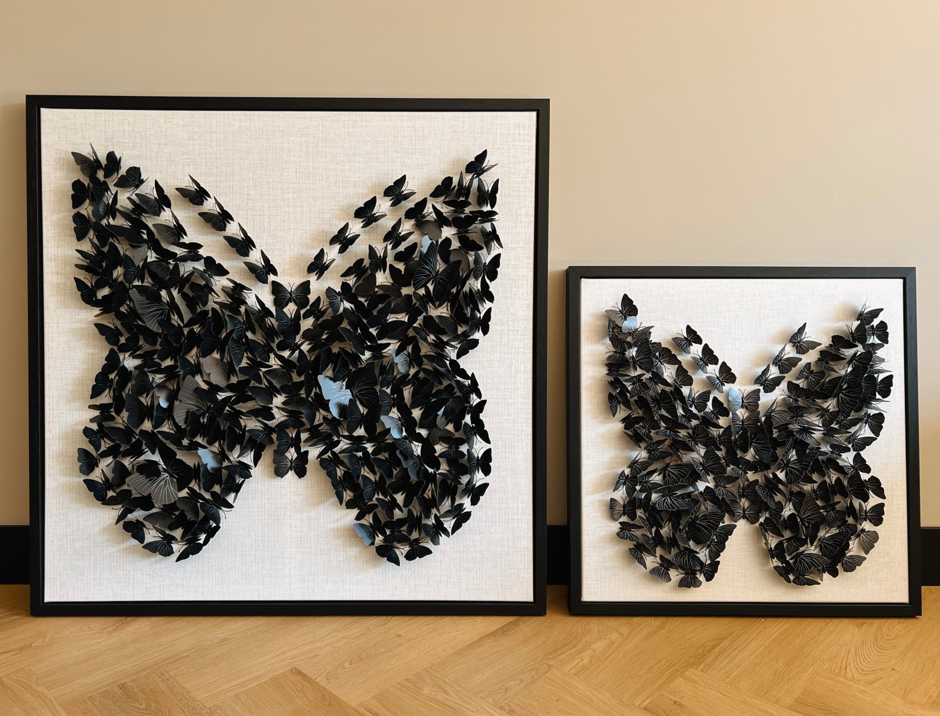 Twee wanddecoraties met een vlinder gevormd uit vlinders